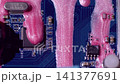 Chip scheme. Ink trickles. Shimmering pink fluid pouring on blue motherboard texture. Color electronics system defocused background. 141377691