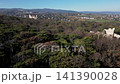 Drone flying by the ruins of an ancient amphitheater towards the city, 4k 141390028