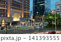 Department Store and illuminated modern skyscrapers in the Umeda district of Osaka, Japan at evening twilight. Busy city traffic with cars and buses driving on the road. 141393555