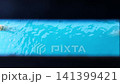 Clear blue pool water rippling viewed through a dark narrow slit 141399421