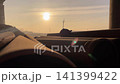 Silhouette of a hard hat on large pipes at a construction site during sunset 141399422