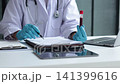 Healthcare professional holding blood sample tube and signing medical document. Healthcare diagnostics and pathology laboratory test results concept. 141399616