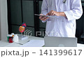 Cardiologist conducting remote heart health consultation using digital tablet. Concept for telehealth or telemedicine. 141399617