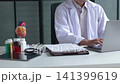 Male doctor cardiologist conducting remote heart health consultation using laptop computer. Concept for telehealth or telemedicine. 141399619