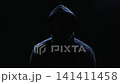 Incognito hooded man silhouette in dark room 141411458