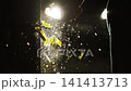 Man smashing a glass bottle in the dark night in bright car headlights 141413713