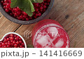 Fresh Red Currants with Green Leaves in Dark Bowl Overhead 141416669