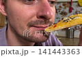 A mam is tasting food at home kitchen 141443363