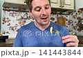 A mam is tasting food at home kitchen 141443844
