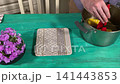 A mam is tasting food at home kitchen 141443853