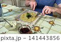 A mam is tasting food at home kitchen 141443856