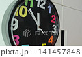 Colorful clock displays time and moves hands to show passing minutes 141457848