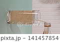 Lemonade pours into a glass during hot summer days in a kitchen 141457854