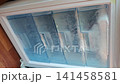 Defrosting the freezer in a home kitchen during a morning routine 141458581