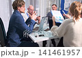 team cheers after investor approval, team applauds and cheers following successful investor meeting, celebrations erupt as team celebrates securing investor approval during important presentation 141461957