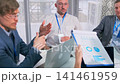 group of analysts analyzing data collaboratively, caucasian data analysts collaboratively studying graphs and charts, team of caucasian analysts reviewing and discussing analytical data around table 141461959