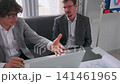 Businessmen discussing project strategy using laptop during office meeting 141461965