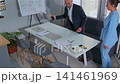 Executives discuss business strategy in a small office meeting 141461969