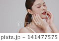 Slow motion of beautiful young Asian girl with k-beauty make up style on isolated white background for commercial beauty advertising. 141477575