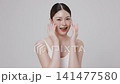 Slow motion of beautiful young Asian girl with k-beauty make up style on isolated white background for commercial beauty advertising. 141477580