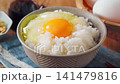 Egg over rice: A breakfast of white rice and a raw egg served in a bowl. 141479816