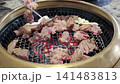 Sizzling Delicious Korean Marinated Pork Ribs (Dwaeji Galbi) Grilling on a Charcoal Grill 141483813