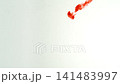 Abstract close-up of blood dissolving and dispersing in water, creating dynamic red swirls and fluid patterns, isolated on a white background, slow motion 141483997