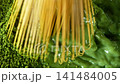 Bamboo Whisk Chasen Mixing Matcha Tea in Macro Close Up 141484005