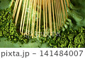Bamboo Whisk Chasen Mixing Matcha Tea in Macro Close Up 141484007