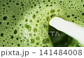 Macro Pour of Milk Into Fresh Matcha Latte , Macro Shot 141484008