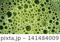 Rotating Macro Close Up of Matcha Tea Surface With Bubbles 141484009
