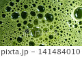 Rotating Macro Close Up of Matcha Tea Surface With Bubbles 141484010