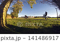 a lot of people passing by on a bicycle path 141486917