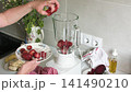 Steps to make homemade ice cream using strawberries, bananas, and beets are shown. Ingredients are prepared in a kitchen with a blender and fresh fruit 141490210