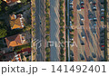 alley with palm trees aerial view, pedestrian street and car road at sunset, promenade at exotic tropical resort, directly above aerial drone view 4k 141492401