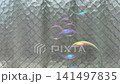 4K video of soap bubbles floating down in front of wired glass. 141497835