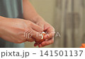 Woman hand peeling boiled egg in kitchen. 141501137