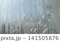 Slow-motion video of soap bubbles crossing in front of wet frosted glass. 141505876