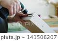 Assembling furniture with screwdriver, close-up of hand and tool in action 141506207