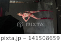 Woman in Red Tape Costume Posing in Studio 141508659