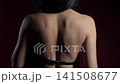 Bold woman showcases leather belt in studio setting with striking poses 141508677