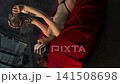 Sensual tattooed woman with a snake on red velvet 141508698