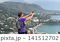 Tourist Taking Selfie Above Coastal Bay 141512702