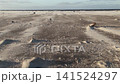 Wind blowing across the sandy beach 141524297