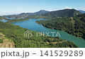 Aerial panorama of Lake Plastiras surrounded by dense green pine forest and Agrafa mountains in Karditsa Thessaly Greece for European nature travel video background 141529289