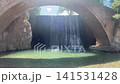 Traditional arched stone bridge framed around cascade waterfall spilling into clear turquoise pool at Paleokarya near Trikala Greece for nature travel video background 141531428