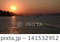 Shining golden sunset over the Mediterranean Sea with silhouettes of mountains on the horizon 141532952