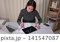一位女士正在網路上查看股票價格的特寫。 141547087