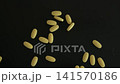 Hand Counting Yellow Pills Top View 141570186