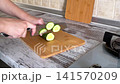 Slicing Fresh Cucumber Close Up 141570209